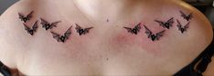 a woman's chest with some bats on it