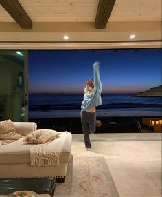 a woman standing in the middle of a living room