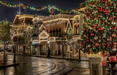 a christmas tree is lit up in the middle of an empty street