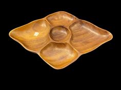 three wooden bowls sitting on top of each other in the shape of a flower arrangement