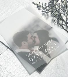 an image of a couple kissing in the snow on their save the date announcement card