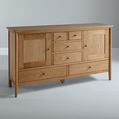 a large wooden dresser sitting on top of a white floor