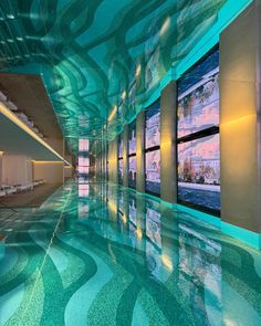 an indoor swimming pool with blue and green water