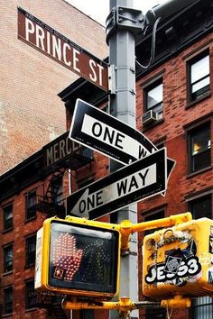 street signs on the corner of prince st and merrick way in new york city