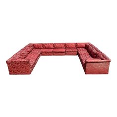 a red couch sitting on top of a white floor