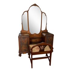 an antique dressing table with mirror and stool