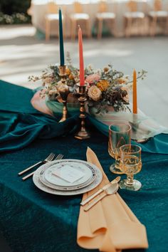 the table is set with candles and place settings