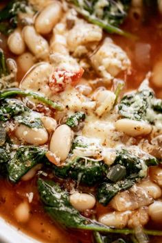 a white bowl filled with beans and spinach