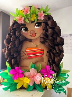 a cake shaped like a girl with flowers in her hair