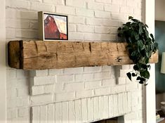 a white brick fireplace with a wooden mantle