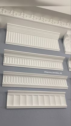 some white molding on the ceiling in a room with gray walls and ceilings,