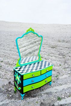 a colorful dresser with a mirror on top of it