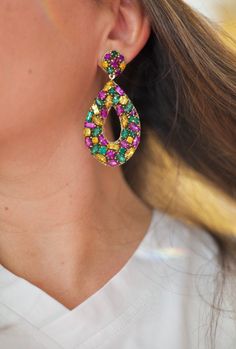 "PRE-ORDER. Ready to be shipped on January 13th, 2023. Mardi Gras Season never looked so glamorous! These sparkly earrings with stones in purple, green and yellow are gorgeous in person and super lightweight. * Handmade * Lead & Nickel Free * 2.75\" length * Lightweight" Multicolor Jeweled Crystal Earrings For Party, Party Earrings With Sparkling Multicolor Stones, Party Multicolor Earrings With Sparkling Stones, Multicolor Party Earrings With Sparkling Stones, Green Crystal Earrings With Sparkling Stones For Party, Glamorous Multicolor Jeweled Crystal Earrings, Multicolor Sparkling Stones Party Earrings, Party Multicolor Sparkling Stones Earrings, Glamorous Multicolor Jeweled Earrings