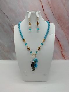 "Handmade and designed by me-one of a kind necklace set-turquoise seed bead crocheted rope necklace-22\" long-Murano glass sea horse focal-glass beads-metal beads-2 3/4\" long matching dangle earrings-goldtone findings-1 1/2\" extender chain-lobster clasp. This beautiful necklace set would make a great addition to your summer wardrobe! Or make it a great gift for Mom!" Handmade Turquoise Dangle Necklace, Multi-strand Hand-strung Beaded Necklaces For Beach, Turquoise Beaded Necklaces With Round Beads, Ocean-inspired, Bohemian Turquoise Crochet Jewelry, Blue Multi-strand Beaded Necklace Gift, Adjustable Multi-strand Turquoise Blue Necklace, Crochet Beaded Necklace Inspire Uplift ⭐, Bead Crochet Rope, Earrings Pendant