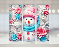 three tall vases decorated with flowers and a snowman on the front one has a pink hat