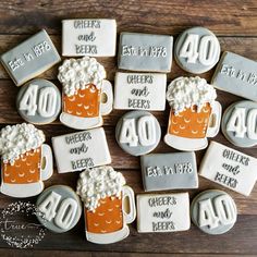 decorated cookies with beer mugs and cheers written on them for 40 years anniversary celebration