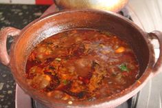 a pot full of food sitting on top of a stove