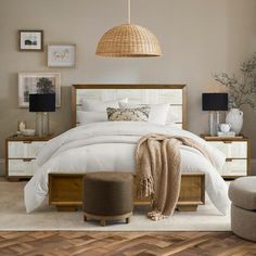 a bedroom with white bedding and wooden furniture