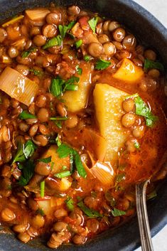 a bowl filled with beans and vegetables on top of a table