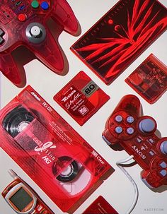 several video game accessories are laid out on a white surface with red and black accents