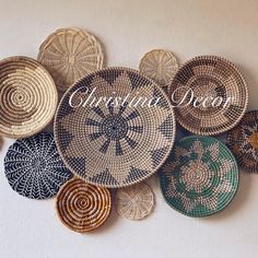 several woven baskets sitting on top of a white wall