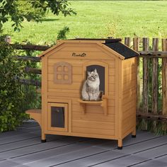 a cat is sitting in a small wooden house