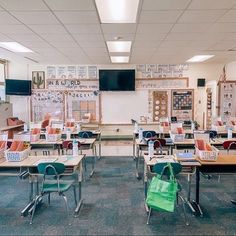 an empty classroom with desks and chairs