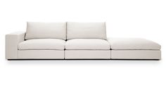 a white couch sitting on top of a white floor