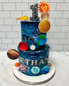 a birthday cake made to look like the solar system with planets on it and an 1