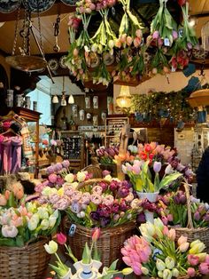 baskets filled with flowers are hanging from the ceiling