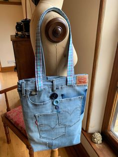 a bag made out of old jeans is sitting on a mannequin's head