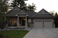 a large house with two garages in front of it