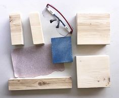 several pieces of wood and some glasses on top of each other with different shades of blue