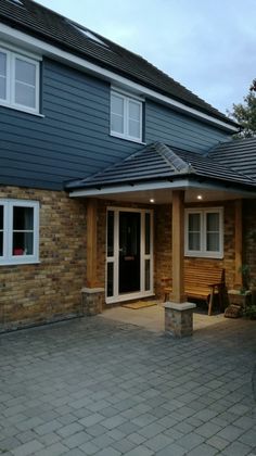 a house with a brick patio and white windows