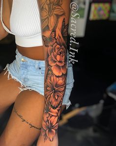 a woman's arm with flowers and butterflies on it