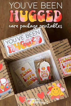 an open cardboard box with the words you've been hugged in red and yellow