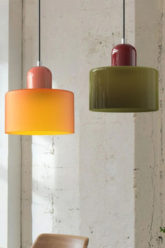 two different colored lamps hanging from the ceiling