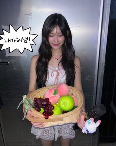 a young woman holding a basket full of fruit in front of her face and an i thought bubble above her head