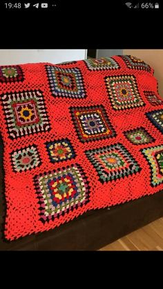 a crocheted blanket is sitting on a couch