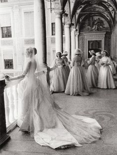 an old black and white photo of brides in formal dress looking at each other