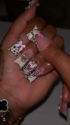 a woman's hand with pink and white nail designs