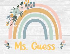 a rainbow with flowers and the word ms guess on it in front of a wooden background