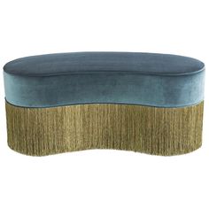 a blue and gold bench with fringe trim on the bottom, sitting in front of a white background