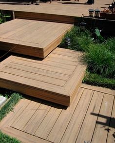 several wooden steps in the middle of some grass and plants on top of each other