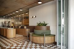 a kitchen with checkered flooring and potted plants