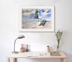 two birds flying in the sky above a desk