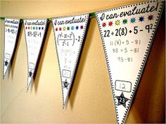 three pennants hanging on the wall with numbers and fractions written on them in black and white