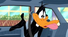 a cartoon duck driving in the back seat of a car with its tongue hanging out