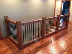 an empty room with wooden floors and railings