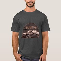 a man wearing a grey t - shirt with an image of a car